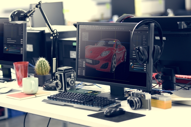 Computer Screen Showing Graphic Car Design on Office Table Worki